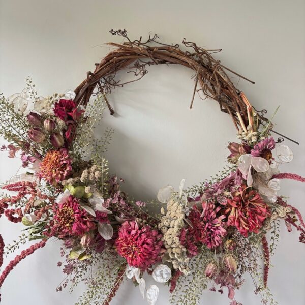 pink and white flowers on grapevine wreath base
